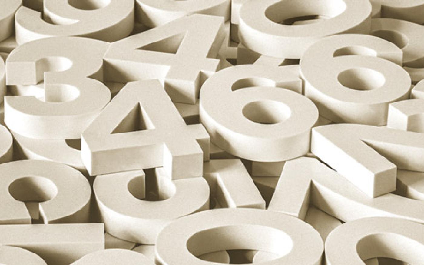 A scattered pile of large white 3D numbers overlapping one another.