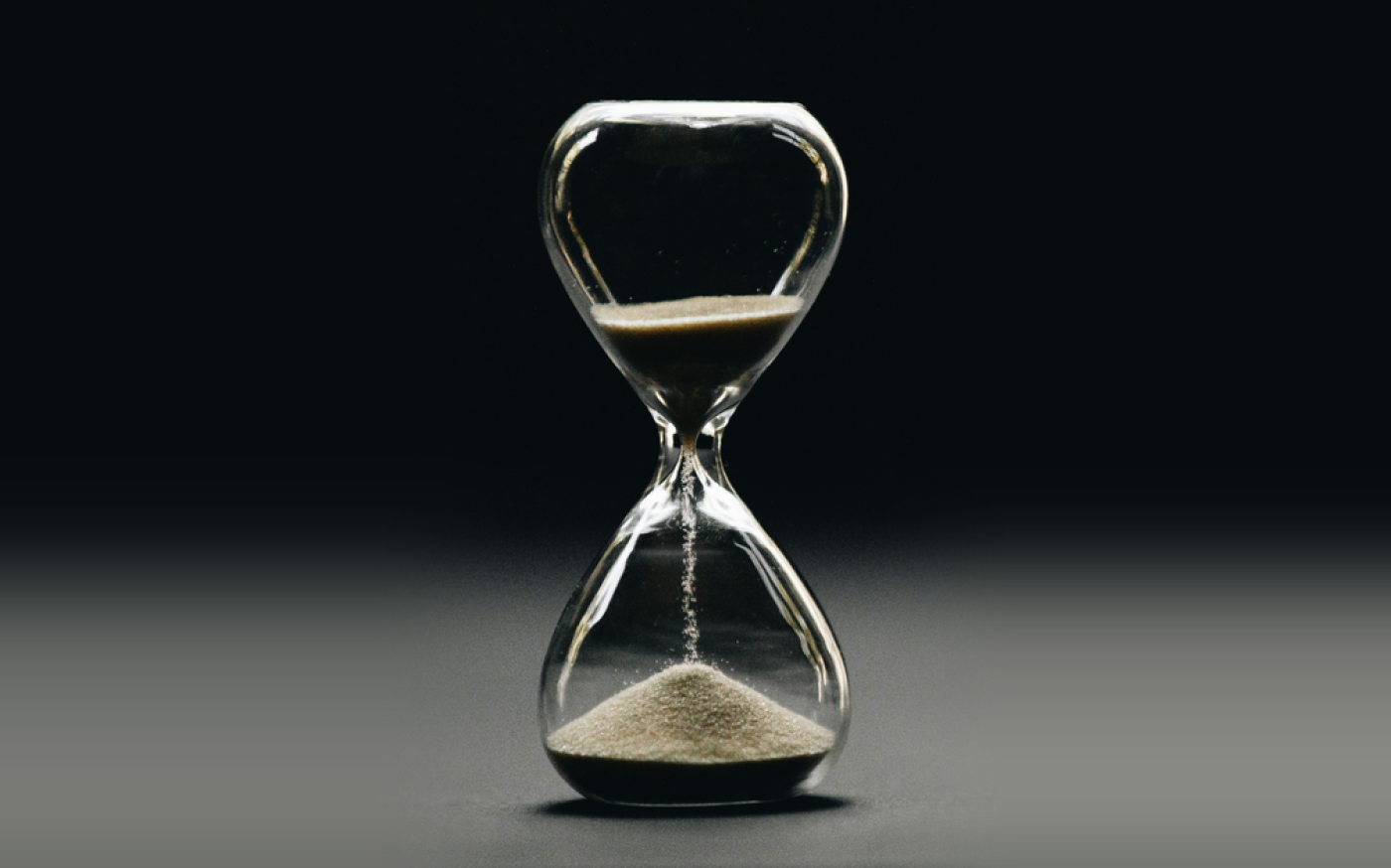 An hourglass with its sand running out