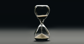 An hourglass with its sand running out